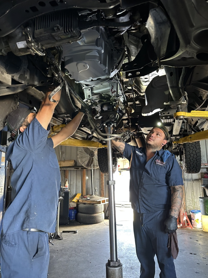 Gama Auto Repair mechanics working under a vehicle